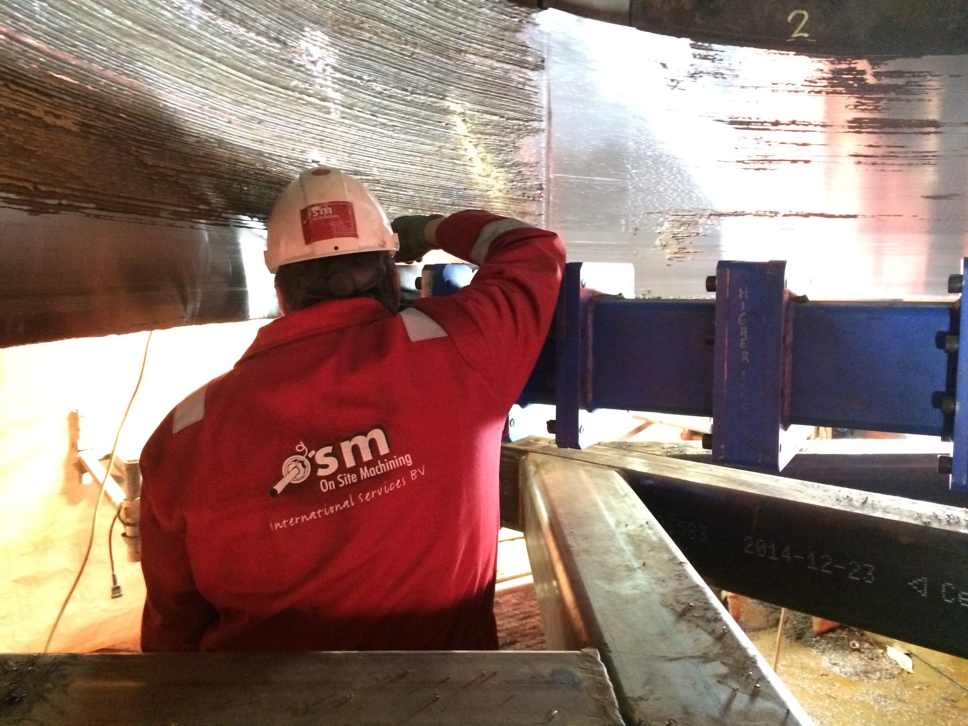 OSM technician performing onsite machining at industrial facility